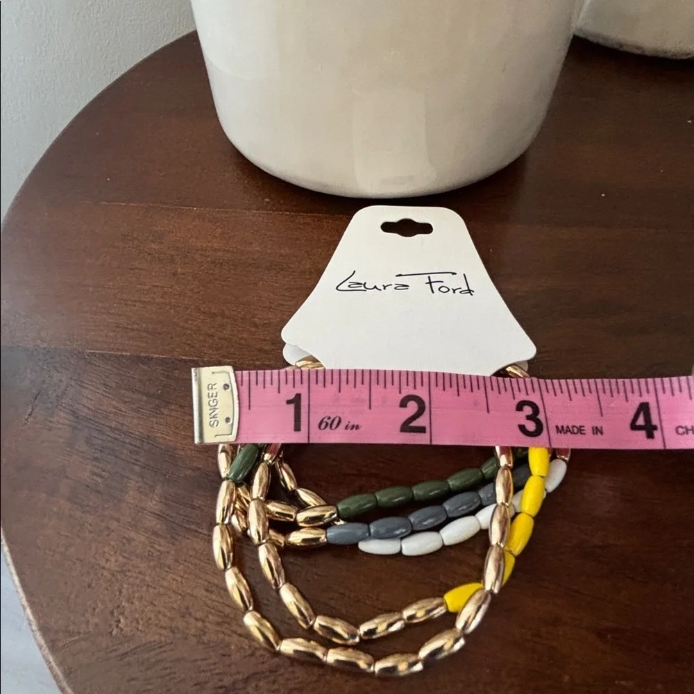Laura Ford Goldtone 5 Row Rice bead yellow,green, blues & white,chunky stretch